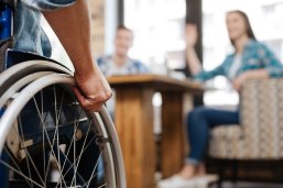 Confident handicapped man meeting his friends Confident handicapped man meeting his friends