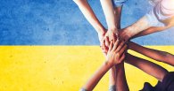 Ukraine people putting their hands together over the national fl Ukraine people putting their hands together over the national fl